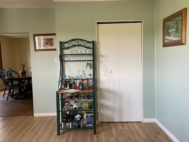 bar area with wood finished floors and baseboards