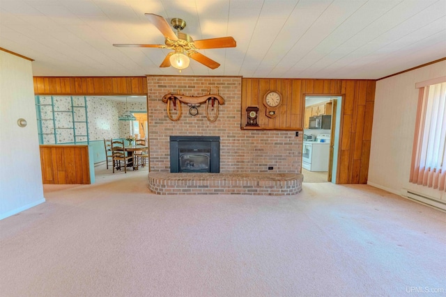 536 N W Gulliver Lake Rd, Gulliver, MI 49840 - unfurnished living room with wood walls, carpet flooring, ceiling fan, baseboards, and ornamental molding