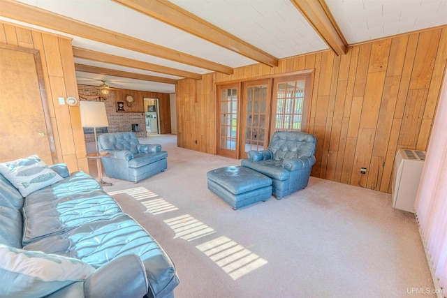 536 N W Gulliver Lake Rd, Gulliver, MI 49840 - living area with french doors, beam ceiling, carpet floors, wood walls, and a brick fireplace