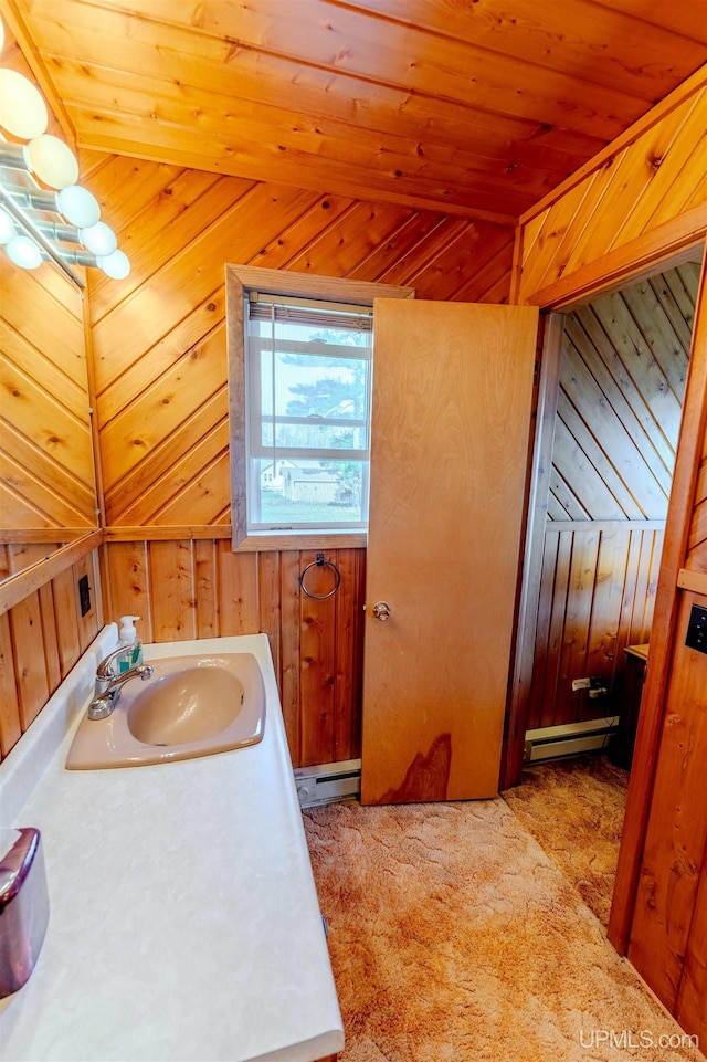 536 N W Gulliver Lake Rd, Gulliver, MI 49840 - bathroom featuring a sink, baseboard heating, wooden walls, and wood ceiling