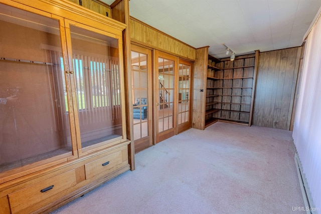 536 N W Gulliver Lake Rd, Gulliver, MI 49840 - spare room with french doors, wood walls, carpet flooring, and a baseboard radiator