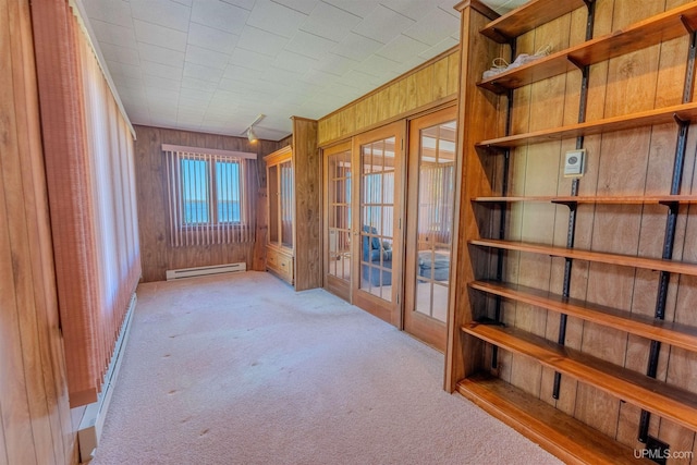 536 N W Gulliver Lake Rd, Gulliver, MI 49840 - hall with french doors, wood walls, a baseboard heating unit, and carpet