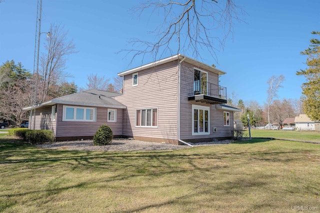 536 N W Gulliver Lake Rd, Gulliver, MI 49840 - back of property featuring a balcony and a lawn