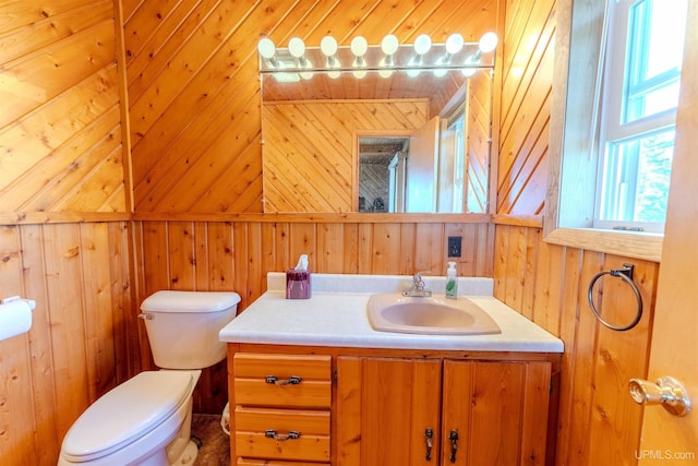 536 N W Gulliver Lake Rd, Gulliver, MI 49840 - half bathroom featuring wooden walls, toilet, and vanity