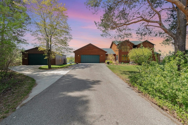 view of front of property featuring a garage and an outdoor structure