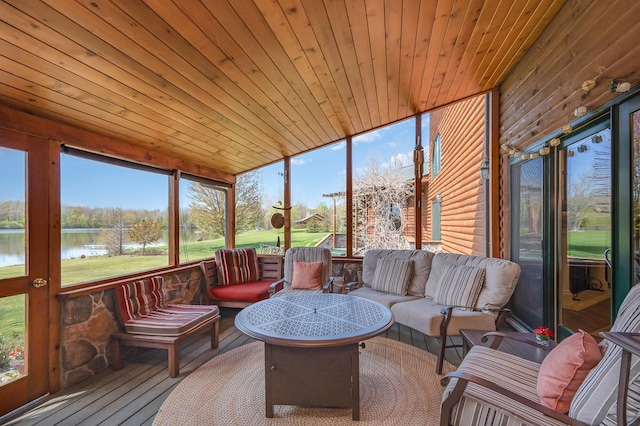 sunroom with a water view and an outdoor living space