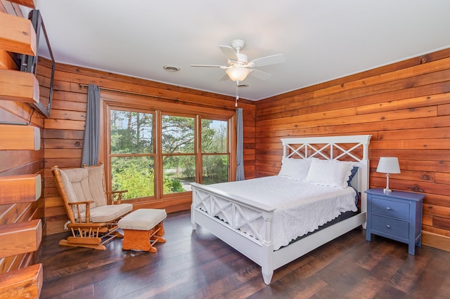 bedroom featuring wooden walls and wood finished floors