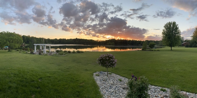 view of grassy yard with a water view