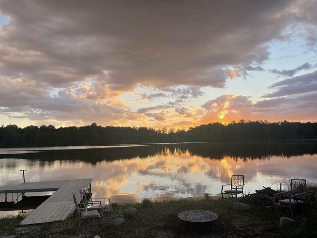 dock area featuring a water view and a forest view