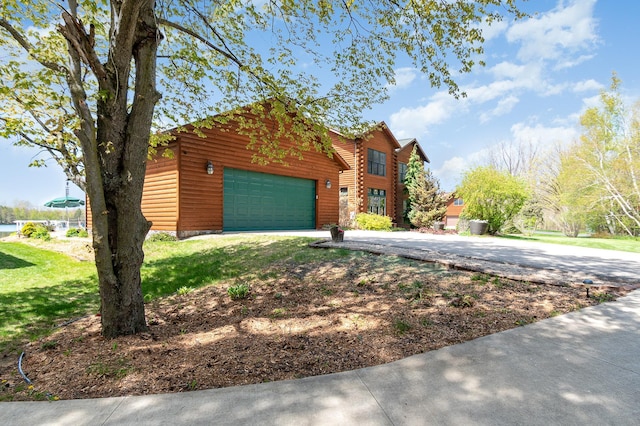 log home featuring driveway, a garage, and a front lawn