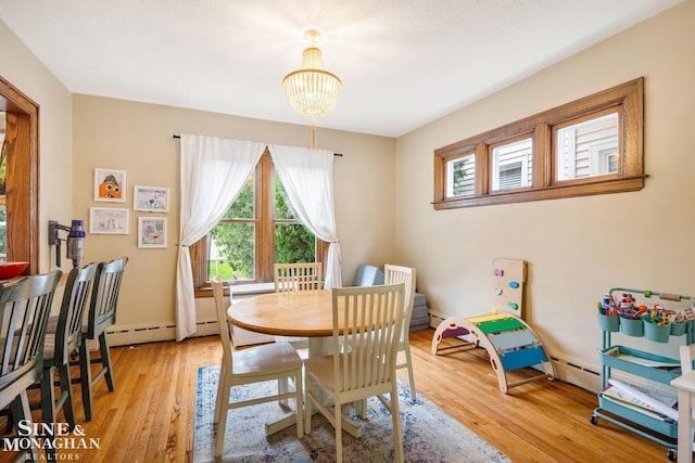 1117 Lakepointe St, Grosse Pointe Park, MI 48230 - dining room featuring healthy amount of natural light, a chandelier, light wood-style floors, and a baseboard heating unit