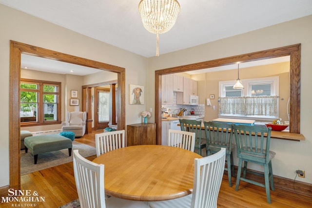 1117 Lakepointe St, Grosse Pointe Park, MI 48230 - dining space with a baseboard radiator, light wood-style floors, and a chandelier