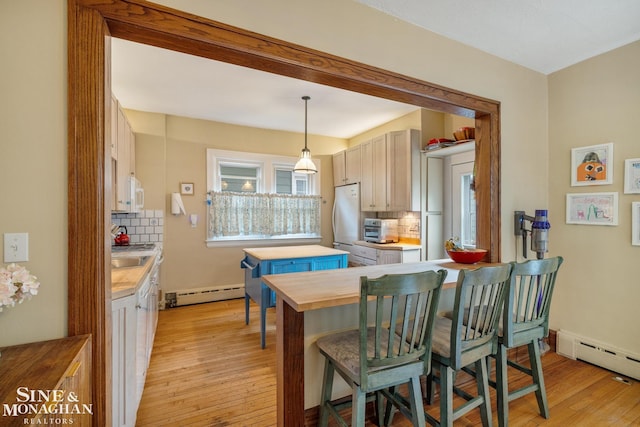 1117 Lakepointe St, Grosse Pointe Park, MI 48230 - kitchen with a baseboard radiator, white appliances, butcher block counters, backsplash, and light wood-type flooring