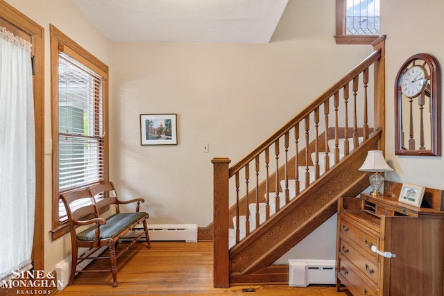 1117 Lakepointe St, Grosse Pointe Park, MI 48230 - stairs with a baseboard radiator, wood finished floors, baseboard heating, and baseboards