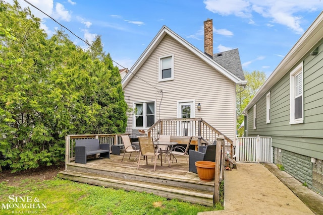 1117 Lakepointe St, Grosse Pointe Park, MI 48230 - rear view of property featuring a chimney, a shingled roof, a deck, and outdoor dining space