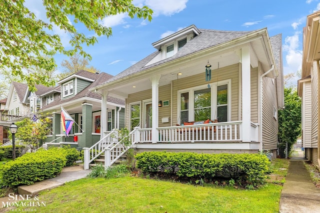 1117 Lakepointe St, Grosse Pointe Park, MI 48230 - bungalow with a porch, a front lawn, and roof with shingles