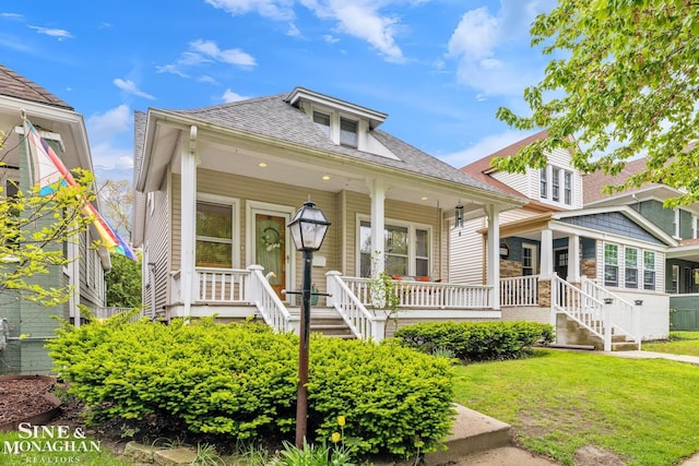 1117 Lakepointe St, Grosse Pointe Park, MI 48230 - bungalow-style home featuring a porch, roof with shingles, stairway, and a front yard