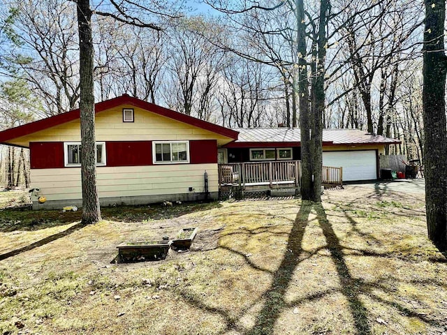 39 Stonegate Hts, Marquette, MI 49855 - view of front of property featuring dirt driveway, metal roof, and an attached garage