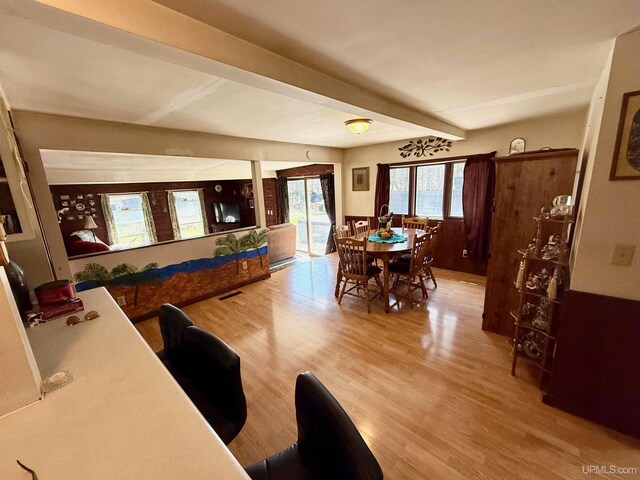 8741 0.8 Ln, Gladstone, MI 49837 - dining room featuring beam ceiling and light wood-style flooring