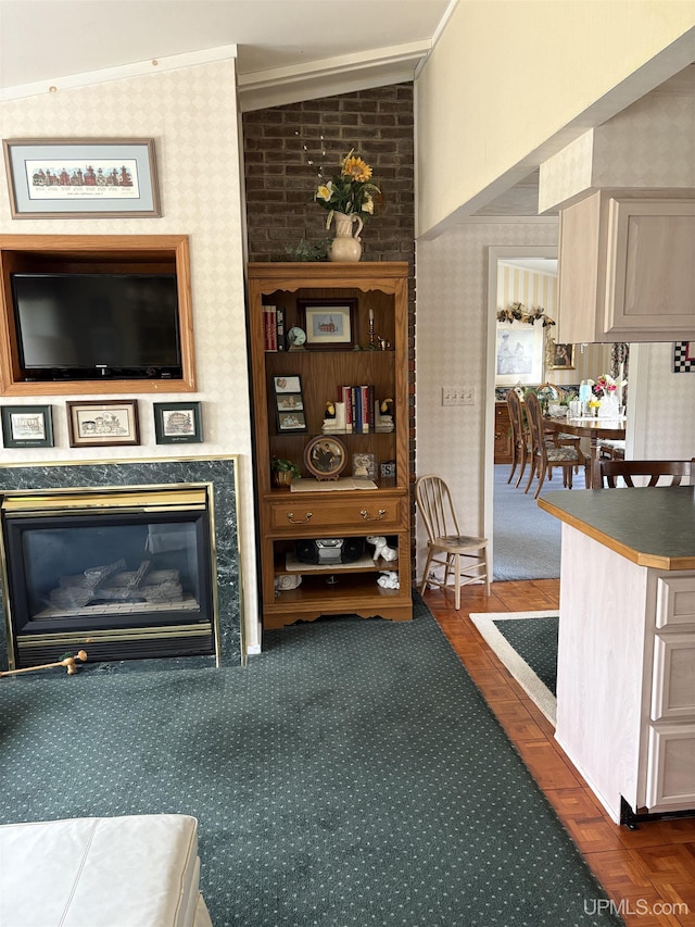 303 Jonathon Carver Rd, Marquette, MI 49855 - living room with wallpapered walls, crown molding, a fireplace, and lofted ceiling