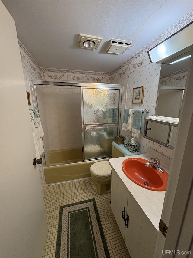 303 Jonathon Carver Rd, Marquette, MI 49855 - bathroom featuring shower / bath combination with glass door, toilet, vanity, and tile patterned floors