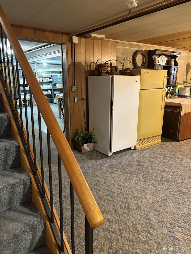 303 Jonathon Carver Rd, Marquette, MI 49855 - basement with freestanding refrigerator, carpet flooring, and stairway