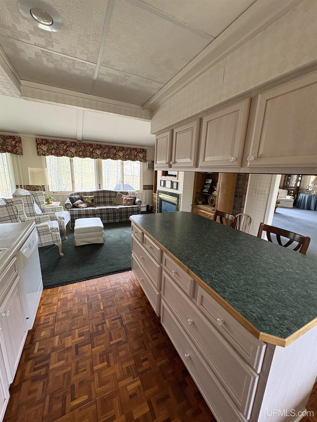 303 Jonathon Carver Rd, Marquette, MI 49855 - kitchen featuring white dishwasher, dark countertops, a fireplace, wall oven, and a breakfast bar