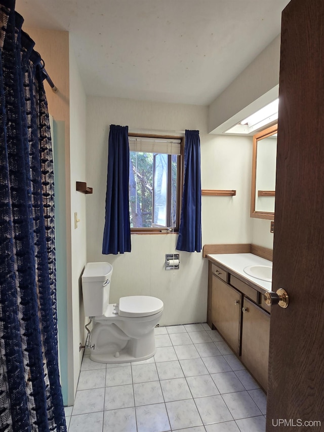 1604 Mildred Ave, Marquette, MI 49855 - bathroom with toilet, tile patterned floors, curtained shower, and vanity
