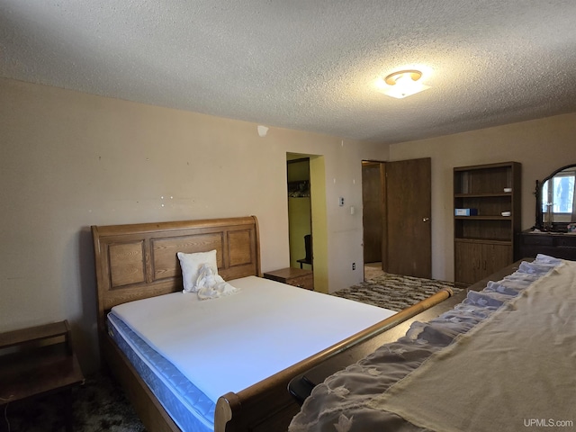 1604 Mildred Ave, Marquette, MI 49855 - bedroom featuring a textured ceiling and a closet