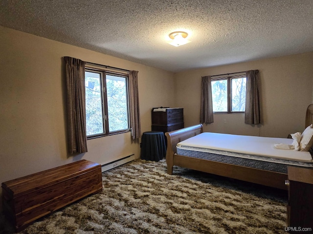 1604 Mildred Ave, Marquette, MI 49855 - carpeted bedroom featuring a baseboard radiator and a textured ceiling