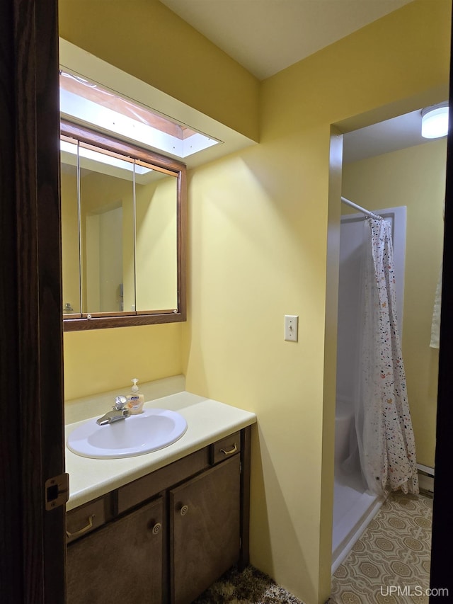 1604 Mildred Ave, Marquette, MI 49855 - full bathroom featuring vanity, a shower with shower curtain, and a skylight