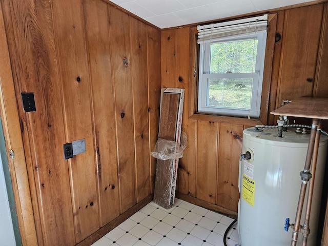 5440 Custer Dr, Harrison, MI 48625 - laundry room with gas water heater, light floors, and wooden walls