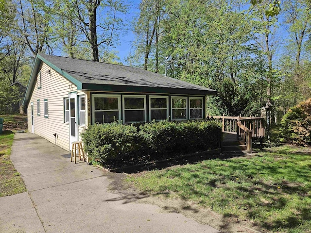 5440 Custer Dr, Harrison, MI 48625 - view of front of property with a deck and roof with shingles