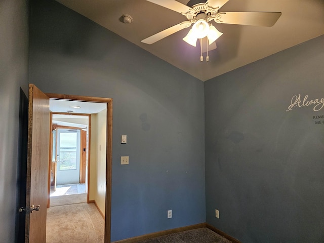 5440 Custer Dr, Harrison, MI 48625 - spare room with light carpet, ceiling fan, baseboards, and vaulted ceiling