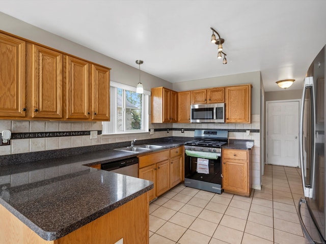55374 Raspberry Dr, Macomb Twp, MI 48042 - kitchen with appliances with stainless steel finishes, a sink, light tile patterned flooring, dark countertops, and decorative backsplash
