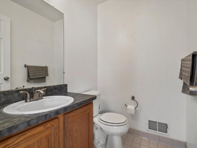 55374 Raspberry Dr, Macomb Twp, MI 48042 - half bathroom with tile patterned floors, toilet, vanity, and baseboards