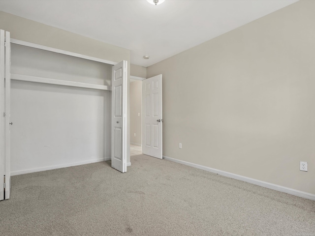 55374 Raspberry Dr, Macomb Twp, MI 48042 - unfurnished bedroom featuring carpet floors, a closet, and baseboards
