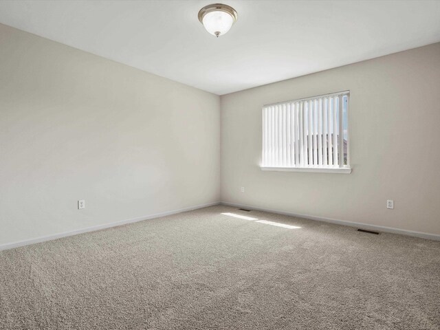 55374 Raspberry Dr, Macomb Twp, MI 48042 - empty room featuring carpet floors and baseboards