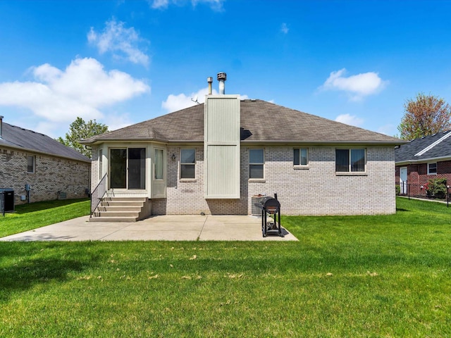 55374 Raspberry Dr, Macomb Twp, MI 48042 - rear view of property featuring entry steps, brick siding, a patio, a lawn, and central air condition unit