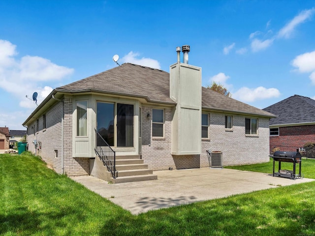 55374 Raspberry Dr, Macomb Twp, MI 48042 - rear view of property with entry steps, brick siding, a chimney, and a yard