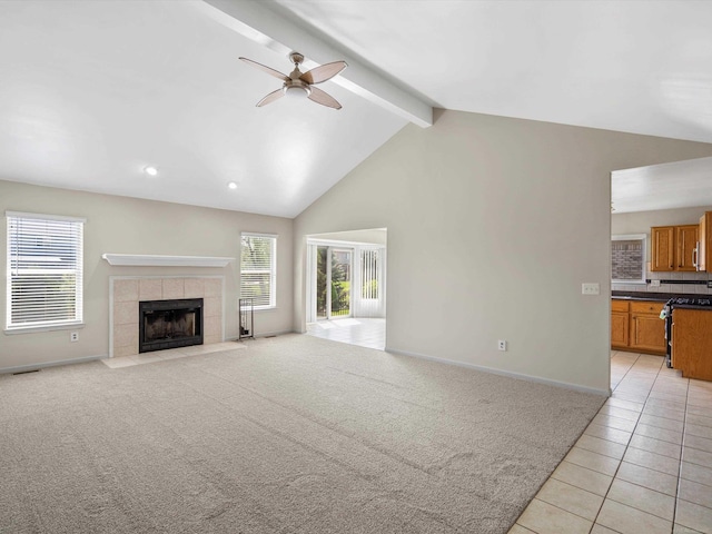 55374 Raspberry Dr, Macomb Twp, MI 48042 - unfurnished living room featuring ceiling fan, beamed ceiling, light tile patterned flooring, a tiled fireplace, and baseboards