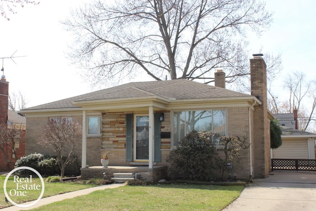 view of front facade featuring brick siding, a front lawn, and a chimney
