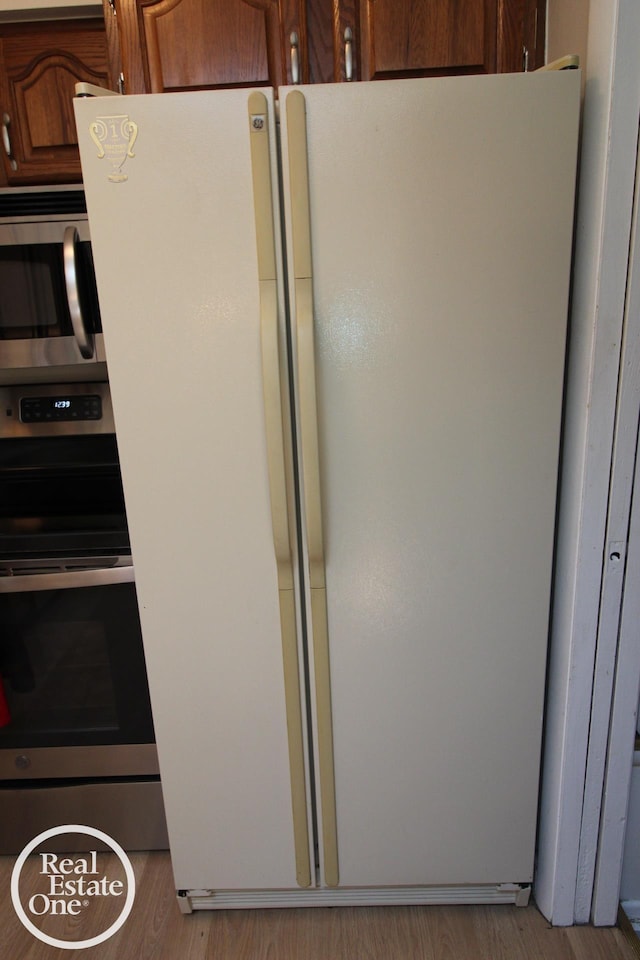 kitchen view of stainless steel appliances and wood finished floors
