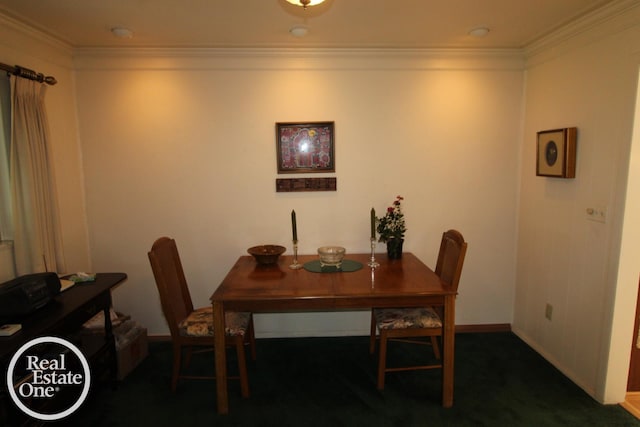 carpeted dining area featuring ornamental molding and baseboards