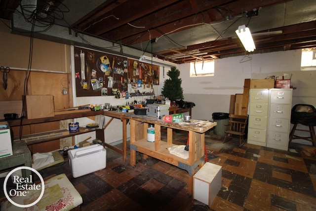 below grade area with a workshop area and tile patterned floors
