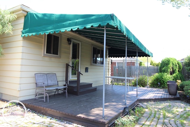 wooden terrace featuring fence