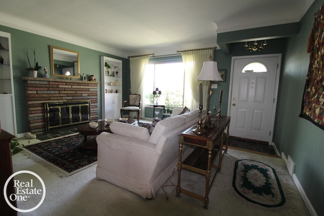 carpeted living area featuring crown molding, a brick fireplace, and a chandelier