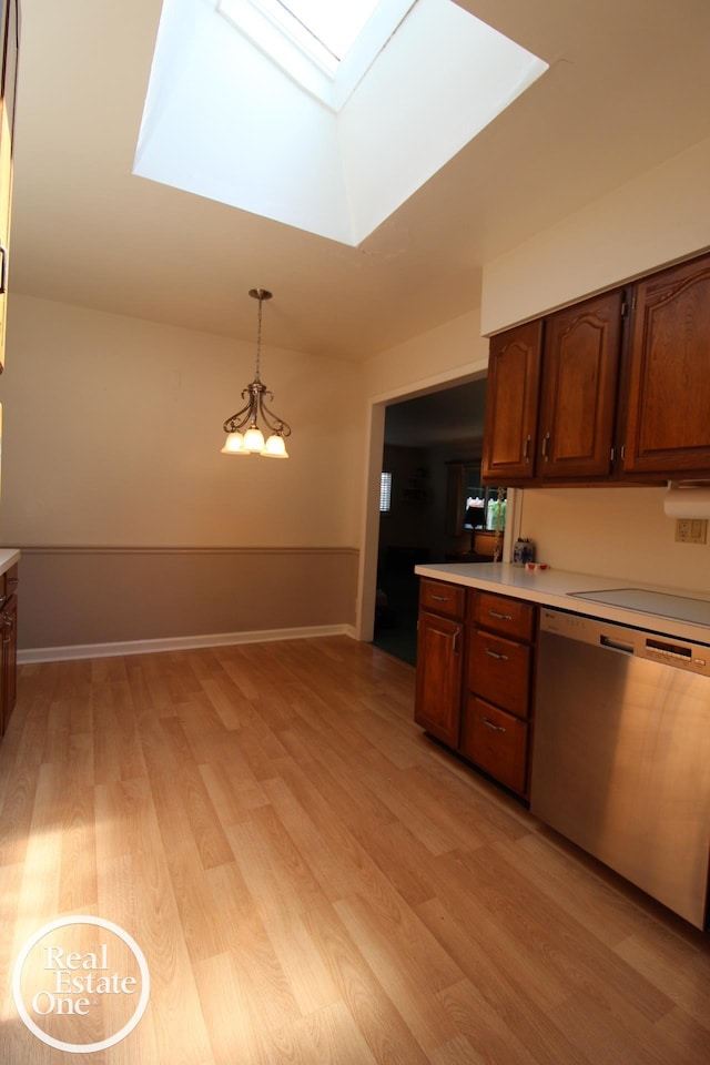 kitchen with dishwasher, a skylight, light wood-type flooring, light countertops, and a chandelier