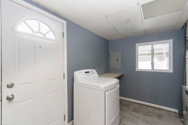 laundry room with washer / dryer, electric panel, baseboards, and light tile patterned floors