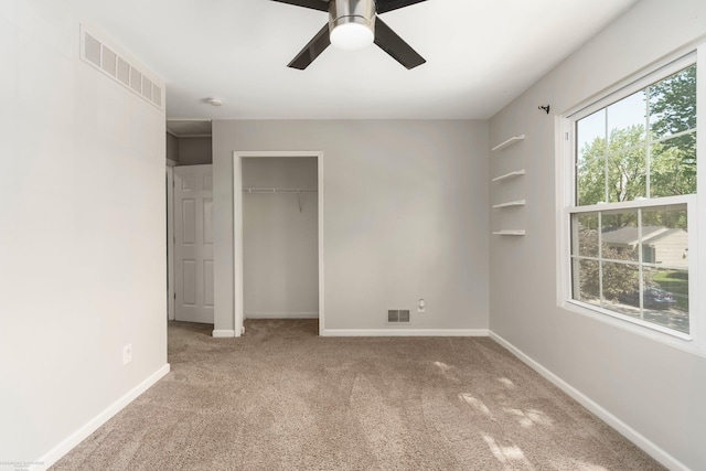 unfurnished bedroom featuring carpet flooring, a closet, baseboards, and a ceiling fan